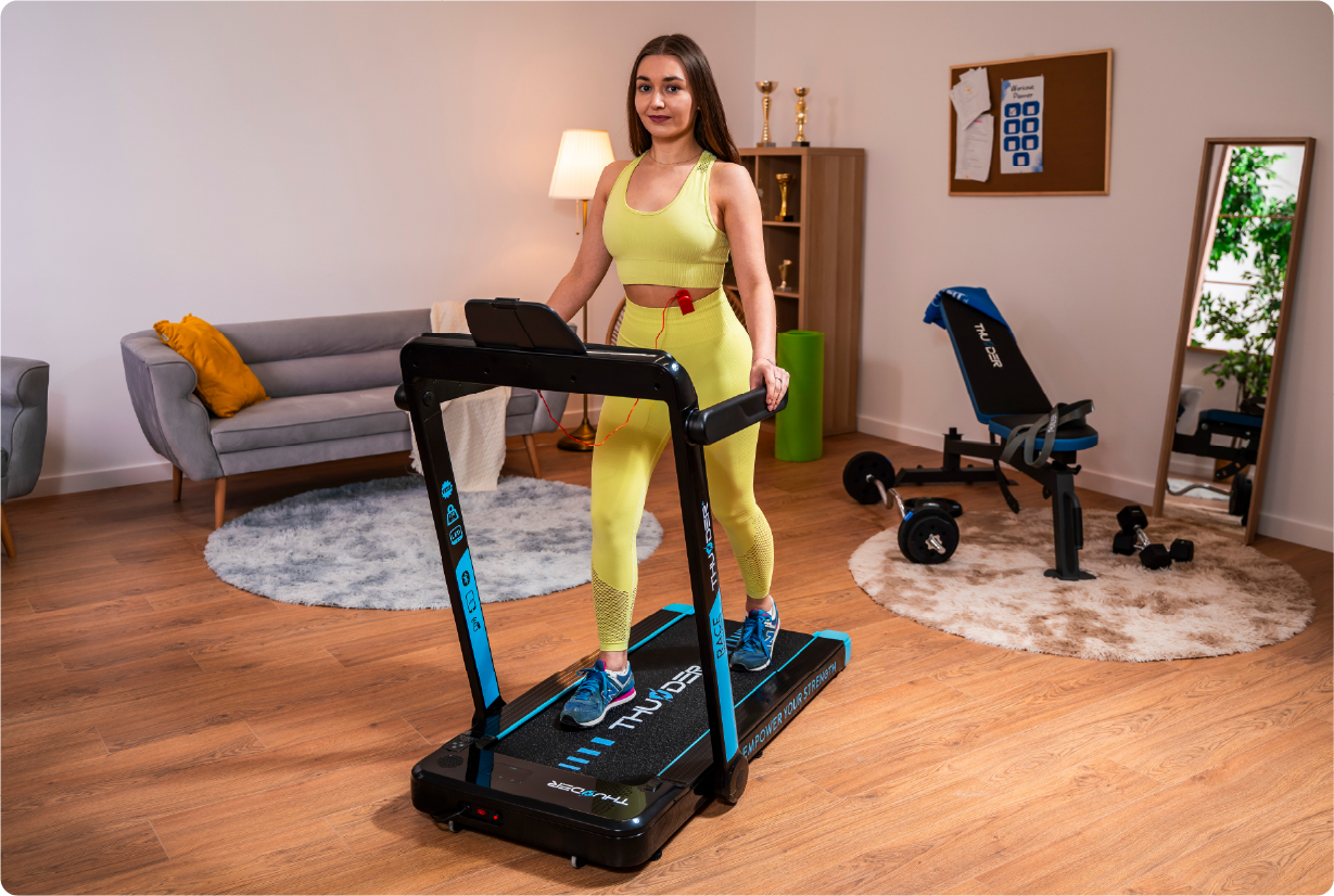 Woman training on a Thunder RACE treadmill at home
